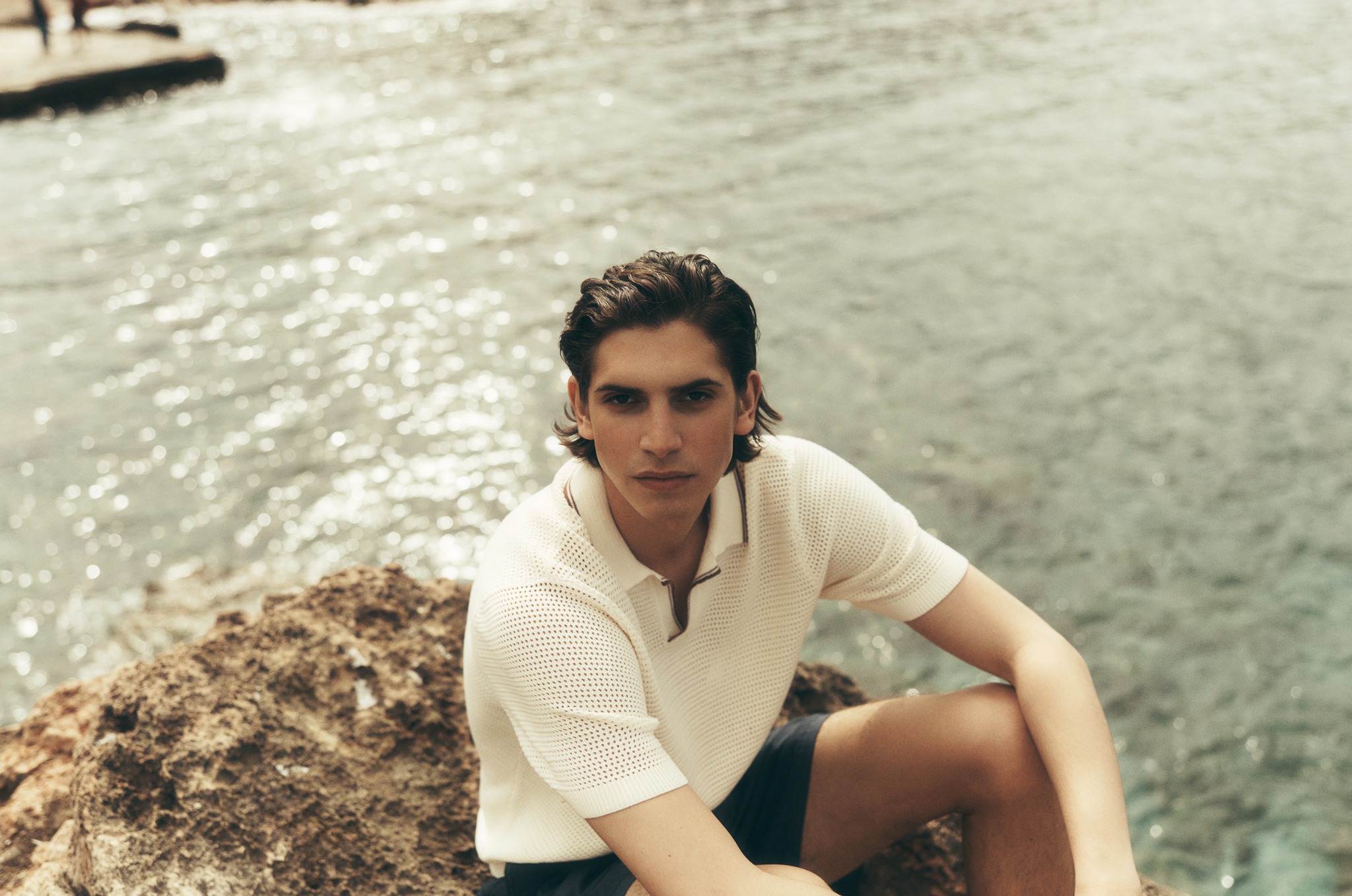 Man seated by the water